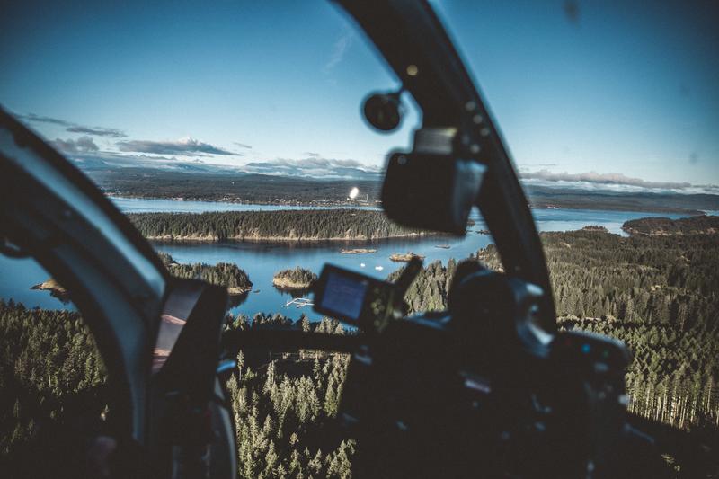 Helicopter passenger view flying over lakes and forests