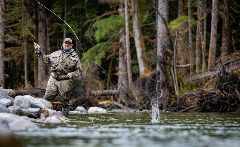 Flyfisherman standing in river and casting