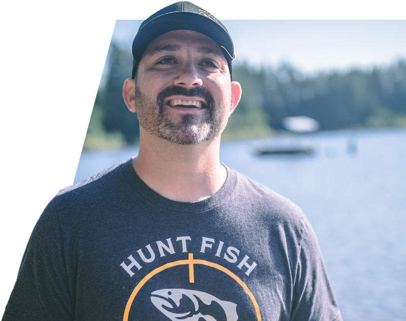 Paul Marier posing in front of a pristine lake