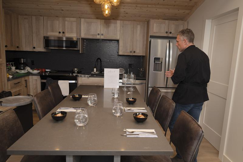 Kitchen island set for dining with water glasses and small bowls.