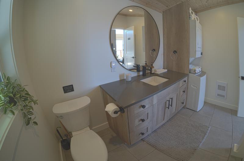 Modern bathroom with large round mirror