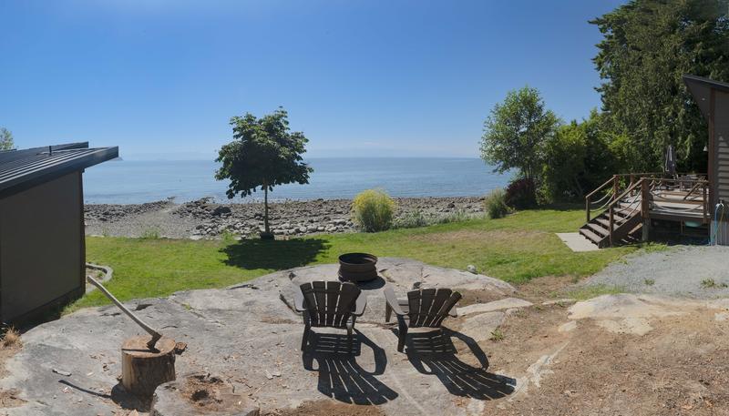 Waterfront view from cabin patio with firepit