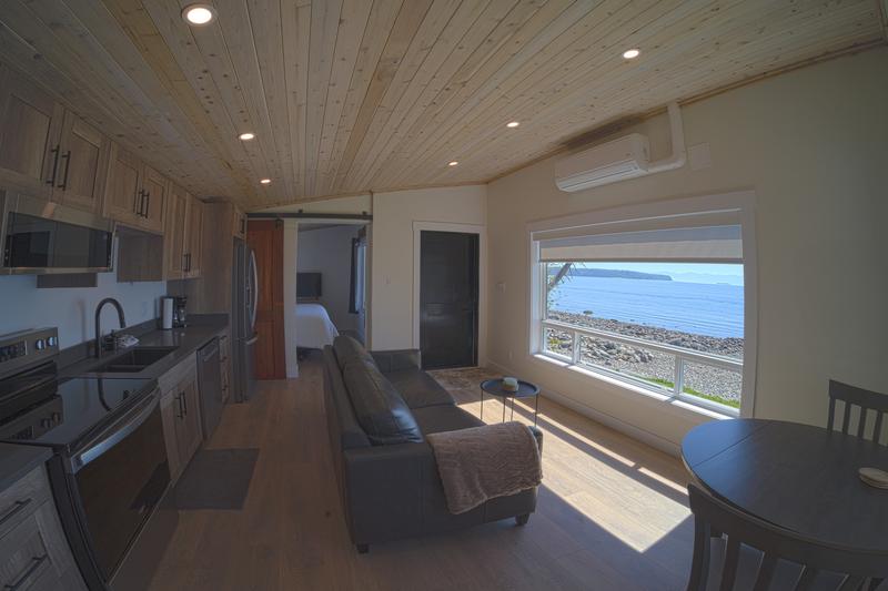 Interior of a waterfront cabin showing kitchen and couch