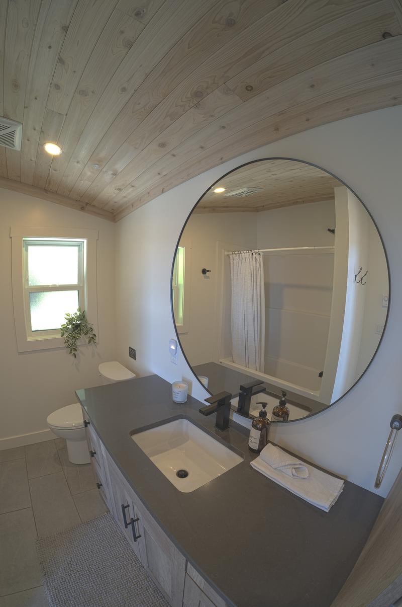 Modern bathroom with large round mirror