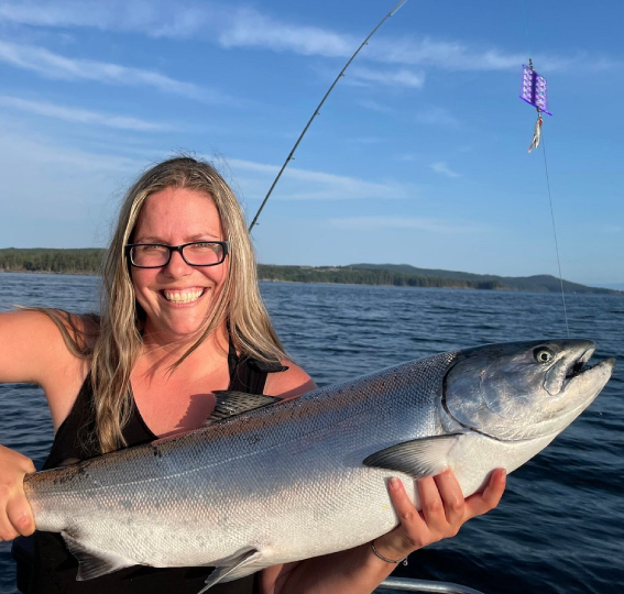 Isabelle holding a fish she caught charter fishing